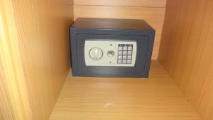 a microwave oven sitting on top of a shelf at De Kolibrie Appartementen in Paramaribo