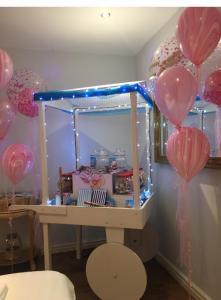 a room with pink and purple balloons and a table at City Centre apartments in Liverpool