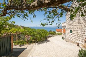 a cobblestone street next to a building with the ocean at Apartments Mira - great location in Splitska