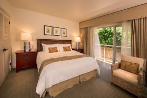 a bedroom with a large bed and a large window at Tradewinds Carmel in Carmel
