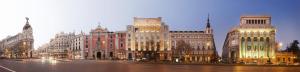 a group of buildings on a city street at night at SOL- CARLOS V Apartaments in Madrid