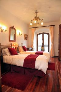 Cama o camas de una habitación en El Hotel de Su Merced
