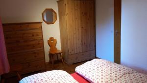 a bedroom with a bed and a dresser and a mirror at Barlangia (255 He) in Valbella