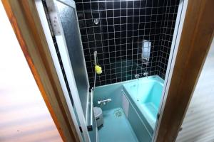a bathroom with a blue tub and a toilet at Riverside Stay Kanazawa in Kanazawa +28 photos