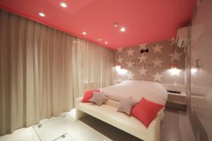 a red and white striped bed in a room at HOTEL SPARK (Adult Only) in Sendai