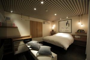 a bedroom with a bed and a desk at HOTEL SPARK (Adult Only) in Sendai