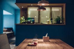 a dining room table with a glass of wine on it at Star Hostel Taipei East in Taipei