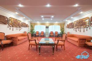 a waiting room with couches and a table and chairs at Otrar in Almaty