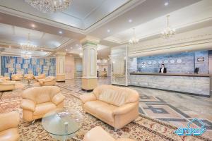 a large lobby with chairs and a bar at Otrar in Almaty