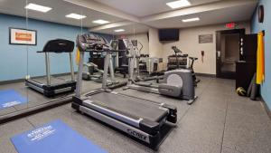a gym with two tread machines and a treadmill at Best Western New Albany in New Albany