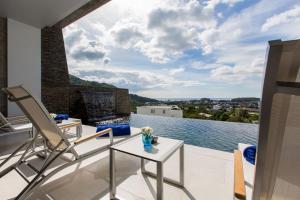 a house with a view of the water at Villa Momo, Kata Phuket in Kata Beach