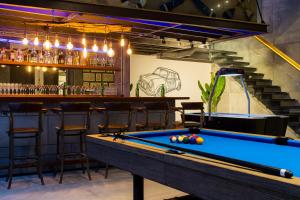 a pool table in a bar with stools at Villa Momo Private Pool near Kata Beach in Kata Beach