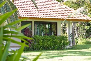 a small house with an orange roof at Heaven Beach Koh Samui in Laem Sor