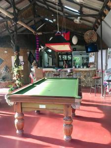 a pool table sitting on a red floor in a room at Carpe Diem Guest House in Ko Chang