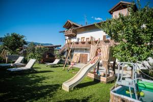 a playground with a slide in a yard at Lochererhof in Appiano sulla Strada del Vino