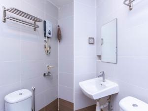 a bathroom with a sink and a toilet and a mirror at I Leaf Boutique Hotel in Johor Bahru +22 photos
