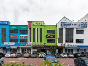 a group of buildings with cars parked in a parking lot at I Leaf Boutique Hotel in Johor Bahru