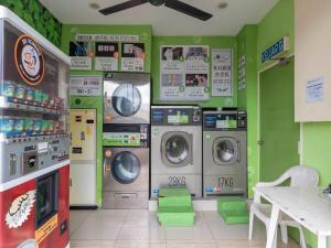 a laund room with four washing machines in a room at I Leaf Boutique Hotel in Johor Bahru