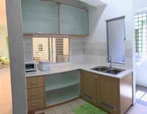 a kitchen with a sink and a counter top at Api Api Centre Apartment Homestay in Kota Kinabalu +2 photos