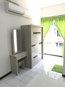 a bathroom with a cabinet and a mirror and a window at Api Api Centre Apartment Homestay in Kota Kinabalu