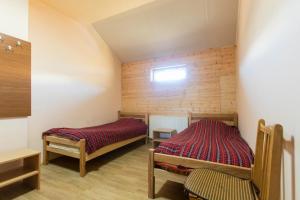 a room with two beds and a window in it at Snow House in Gudauri