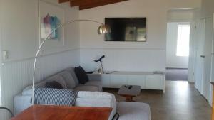 a living room with a couch and a table at 4 Bounty in Corinella