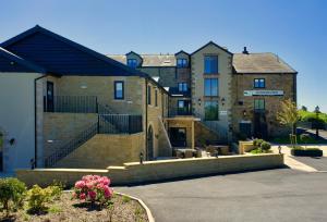 a large brick building with stairs in a parking lot at The Mill at Conder Green in Conder Green
