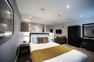 リバプールにあるSeel Street Apartments by EPICのベッド1台、薄型テレビが備わるホテルルームです。