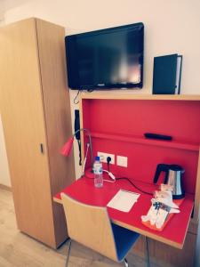 a red desk with a tv on top of it at Best Western Hotel du Mucem in Marseille