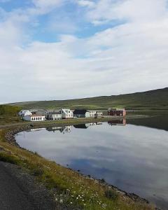 a large body of water with houses and buildings at Tangahús Guesthouse in Borðeyri