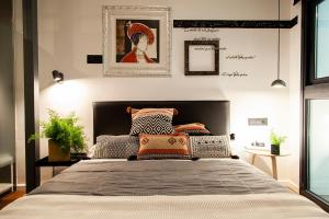 a bedroom with a large bed with pillows on it at Welldone Placentines in Seville +64 photos
