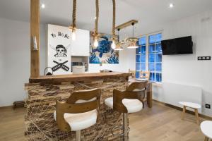 a barber shop with a stone counter and chairs at La Cordee by Cocoonr in Saint Malo