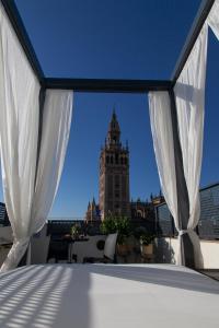 a view of a clock tower from a balcony at Welldone Cathedral in Seville