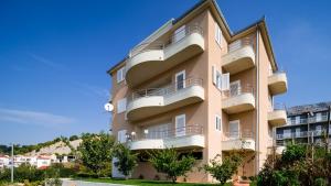 a tall apartment building with balconies on it at Apartment Toma in Podstrana