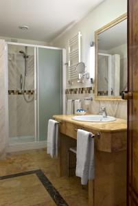 a bathroom with a sink and a shower at Versilia Palace Hotel in Marina di Pietrasanta