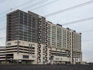 a large apartment building with many windows at Hotel Holmes Gp in Nusajaya