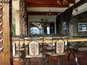 a dining room with a table and chairs at Complex Padina Ursului Fundata in Fundata