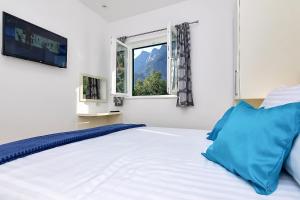 a bedroom with a bed with a television and a window at Holiday home Sergio in Bast +31 photos