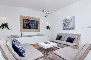 a living room with two chairs and a table at Holiday home Sergio in Bast