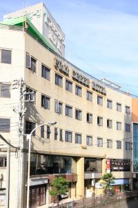 a large building on the corner of a street at Fuji Green Hotel in Fuji