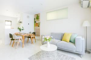 a living room with a couch and a table at Andnext Holiday House in Kyoto