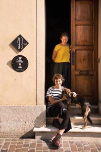 un garçon et un chien assis à la porte dans l'établissement Le 33, à Bassano del Grappa