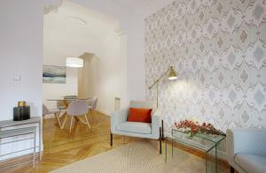 a living room with a chair and a table at Genteel Home Chamberí in Madrid