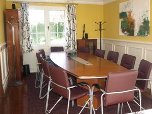 a conference room with a wooden table and chairs at LASAILEKU in Bilbao +23 photos