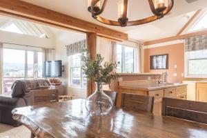 a kitchen with a wooden table with a vase on it at Saddle Ridge Townhome | Unit J1 in Big Sky