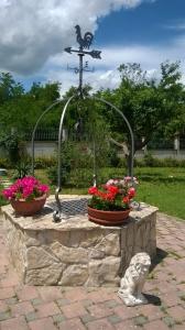 a fountain with a statue of a bird and flowers at mela__bii in Sulmona