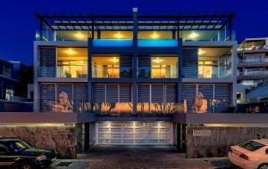 een groot huis met een auto ervoor geparkeerd bij Blue Views Villas and Apartments in Kaapstad