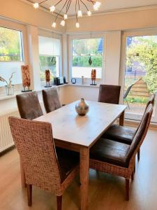 a dining room with a wooden table and chairs at Ferienhaus Strandgut in Zingst