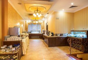 a large room with a kitchen with tables and a counter at ApartComplex Splendid in Saints Constantine and Helena