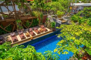 an overhead view of a pool with chairs and trees at Golden Temple Residence in Siem Reap